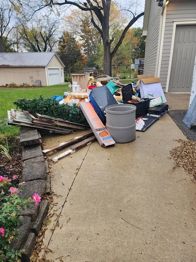 Dumpster being loaded with debris for Estate Cleanout Dumpster Rental in Germantown
